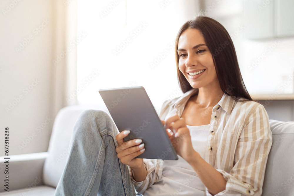 Great App. Happy Female With Digital Tablet Sitting On Couch At Home Great App. Happy Female With Digital Tablet Sitting On Couch At Home