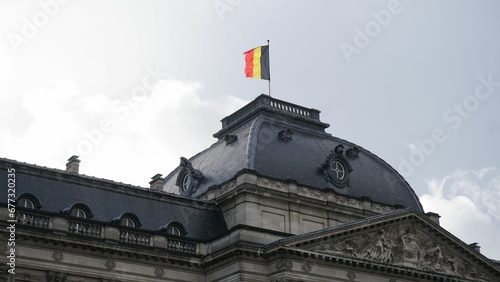 Closeup shot of the flag of Belgium on top of a historical building