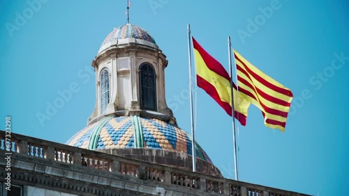 Spanish and Catalan flags waving atop the Palau de la Generalitat de Catalunya palace in Barcelona photo