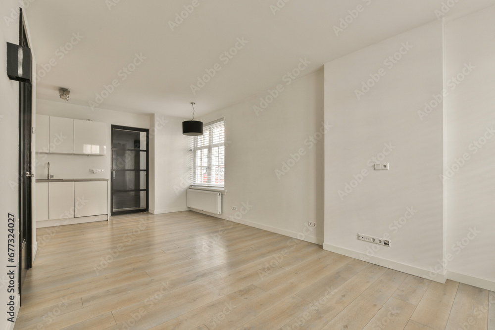 an empty living room with wood flooring and white walls in the room is very clean, but there is no furniture an empty living room with wood flooring and white walls in the room is very clean, but there is no furniture