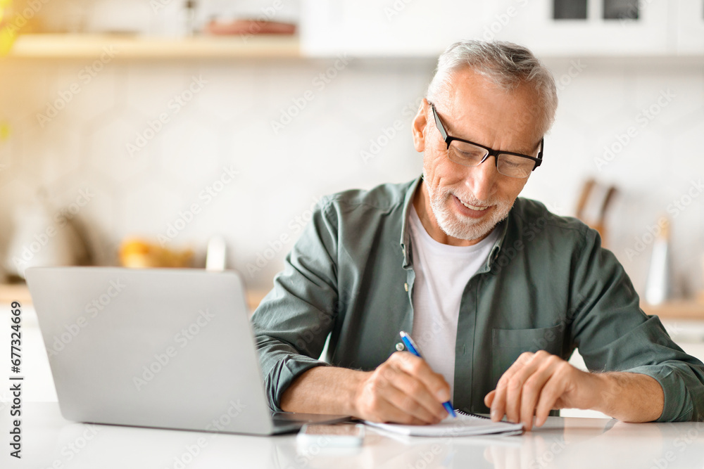 Online Learning For Older Adults. Senior Man Using Laptop And Taking Notes Online Learning For Older Adults. Senior Man Using Laptop And Taking Notes