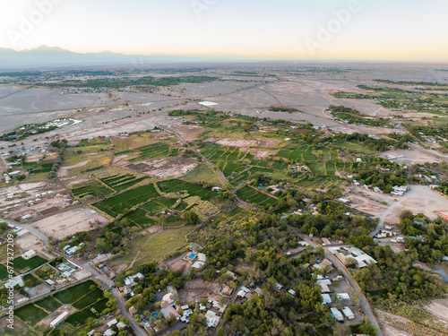 Vista aérea da cidade San Pedro de Atacama pela manhã com o deserto do atacama ao fundo. Contraste entre casas, vegetação e deserto. photo