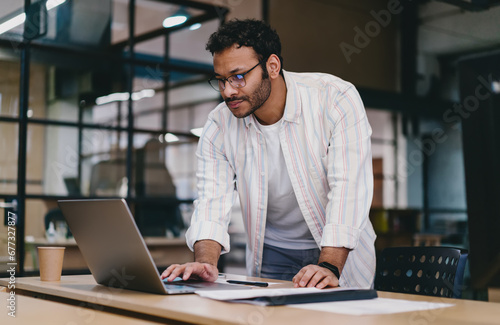 Focused man using laptop in office