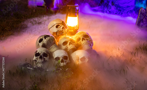 Halloween decoration with skulls in a pile on grass with fog © F Armstrong Photo