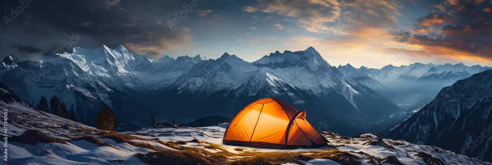 Tent nestled in snowy mountain landscape under a starlit sky 