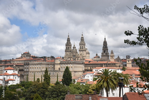 view of the cathedral of Santiago in Spain, blue sky with some clouds and red roofs of the surrounding houses.