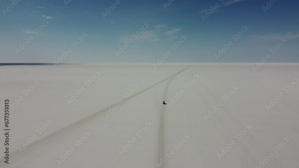 Camera following rising up high behind a small white van driving into