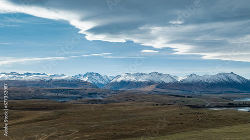 Agricultural fields and rural farming country on the shores of Lake Tekapo under dramatic cloudscape