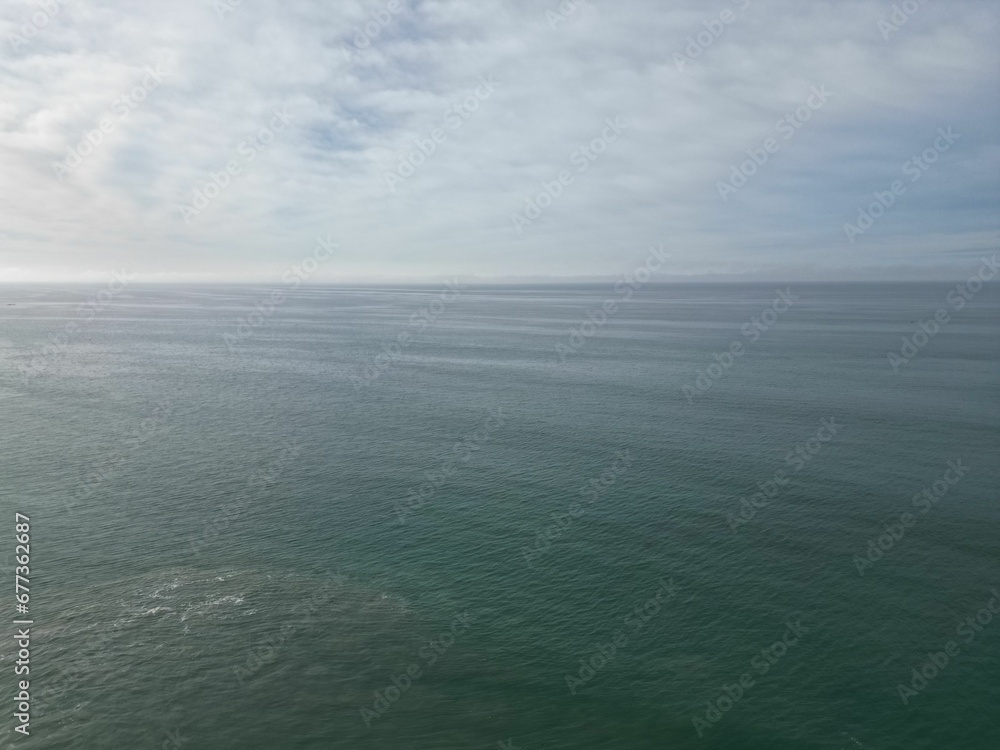 Beautiful aerial scene over large gray sea dunes with cloudy sky on the horizon Beautiful aerial scene over large gray sea dunes with cloudy sky on the horizon