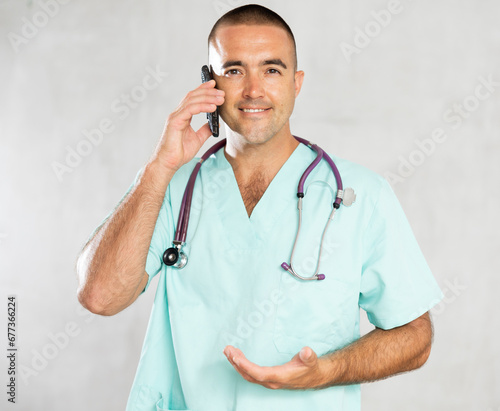 Engaged in direct telephonic conversation, male physician imparts medical insights remotely.