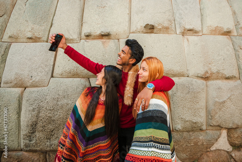 group of peruvian happy friends taking a selfie in cusco peru