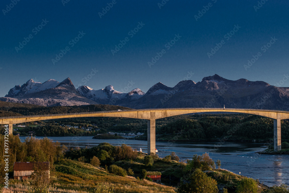Norwegian Landscape: Bridge Over a River Amidst Majestic Mountains