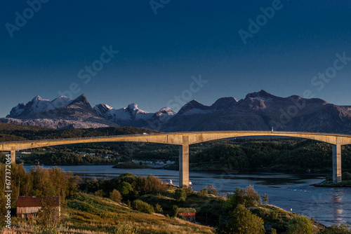 Obraz na płótnie Norwegian Landscape: Bridge Over a River Amidst Majestic Mountains w salonie