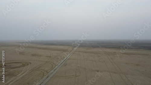 Bird's eye view of a car parked on a road on barren land near Shakambhari Lake in India photo