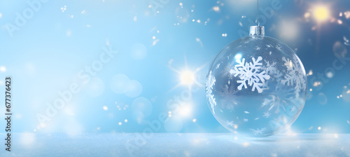 Transparent Christmas ball with snowflake on the blue boke background
