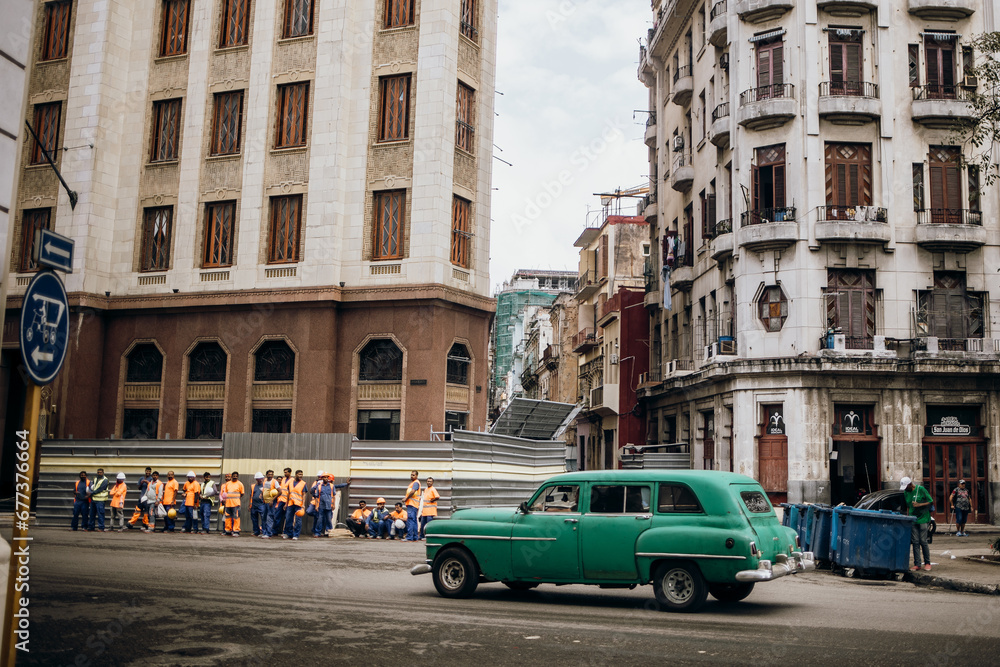 Urban Intersection with Classic Green Car in Havana, Cuba