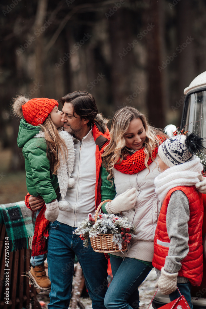 Fototapeta premium Happy family spending time together winter holidays season near Xmas old bus outdoor
