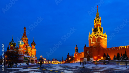 View of illuminated Spasskaya Tower and Saint Basils Cathedral on Red Square in Moscow on winter evening, Russia photo