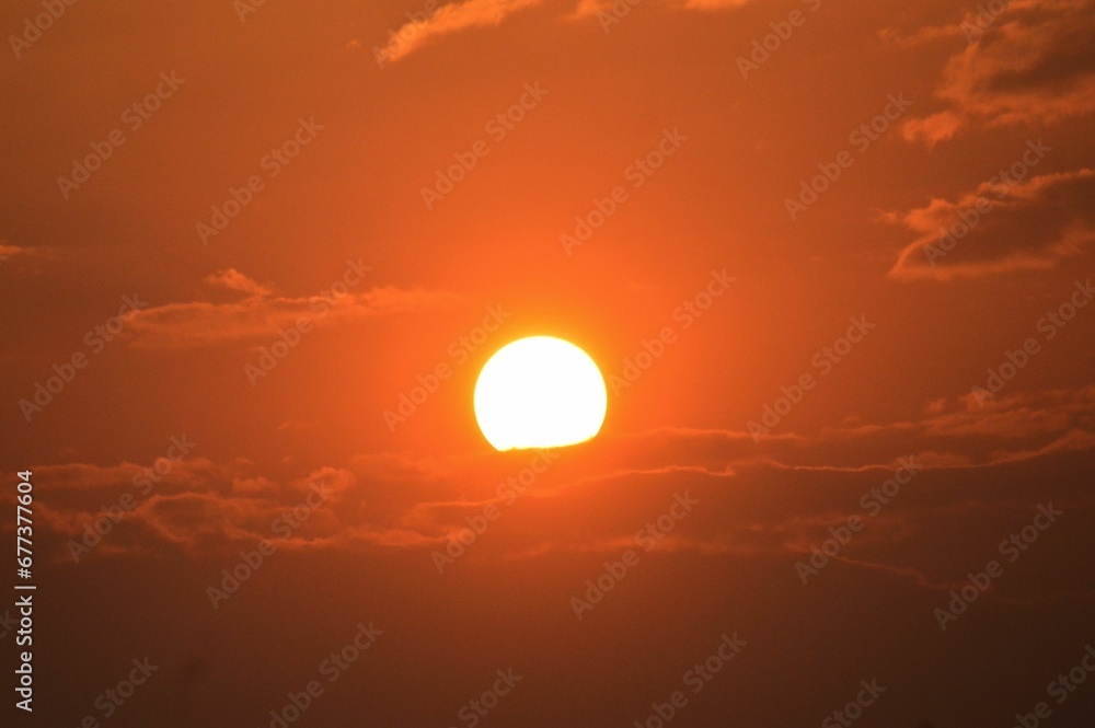 Beautiful shot of the sun in the orange sky