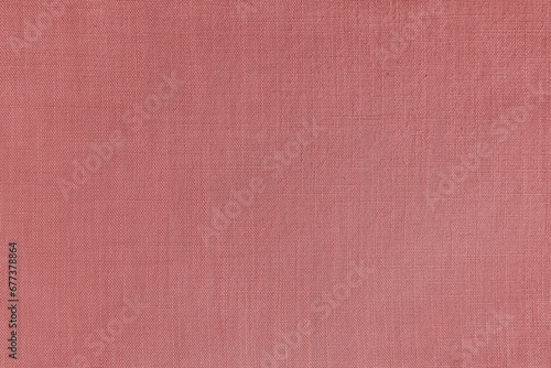 Texture background of red linen fabric. Textile structure, cloth surface, weaving of natural cotton fabric closeup, backdrop, wallpaper.
