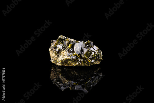 epidote crystals cluster isolated on black background. macro detail close-up rough raw unpolished semi-precious gemstone