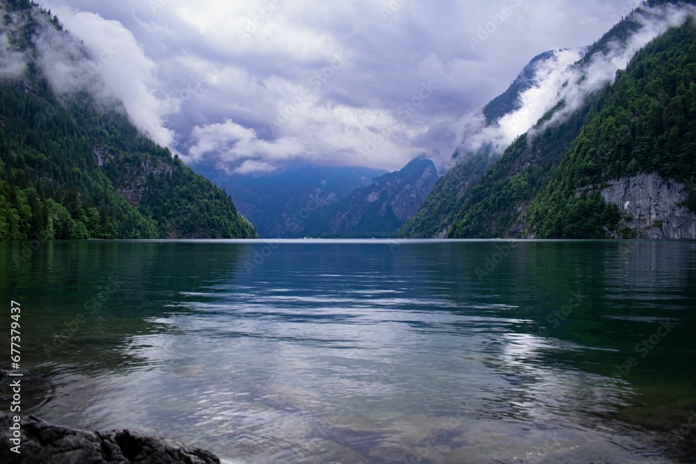 Scenic shot of Lake Konigssee surrounded by mountains and green forests in Bavarian Alps, Germany