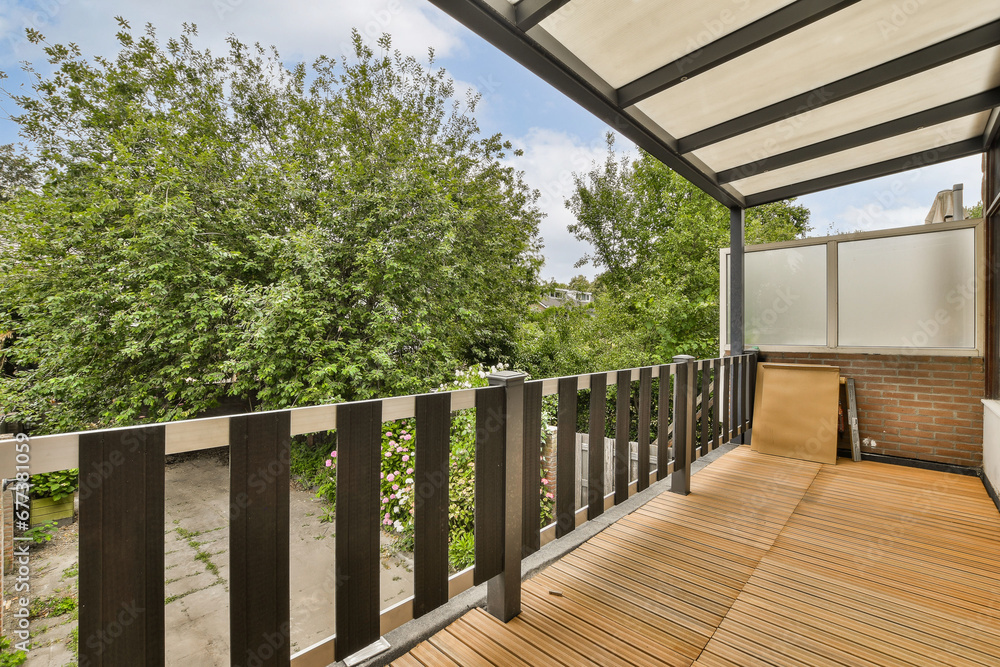 an outside area with wood flooring and wooden fenced in front of the house, surrounded by lush green trees an outside area with wood flooring and wooden fenced in front of the house, surrounded by lush green trees