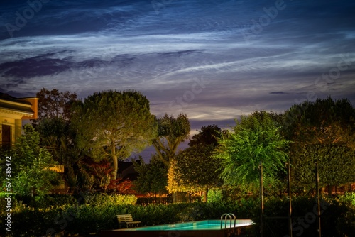 Closeup shot of a swimming pool in the park at dark night © Wirestock