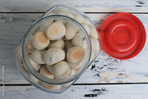 Indonesian snack called ndok bulus in a jar on a the table photo