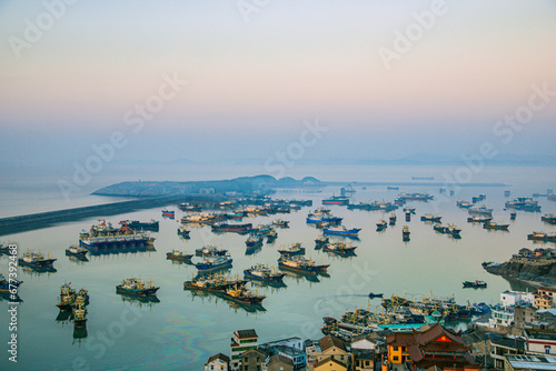 Xiaoruo Village, Wenling City, Taizhou City, Zhejiang Province - high angle view of fishing village and fishing port at sunrise photo