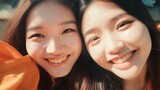 Two asian young women happy smiling and taking selfie.