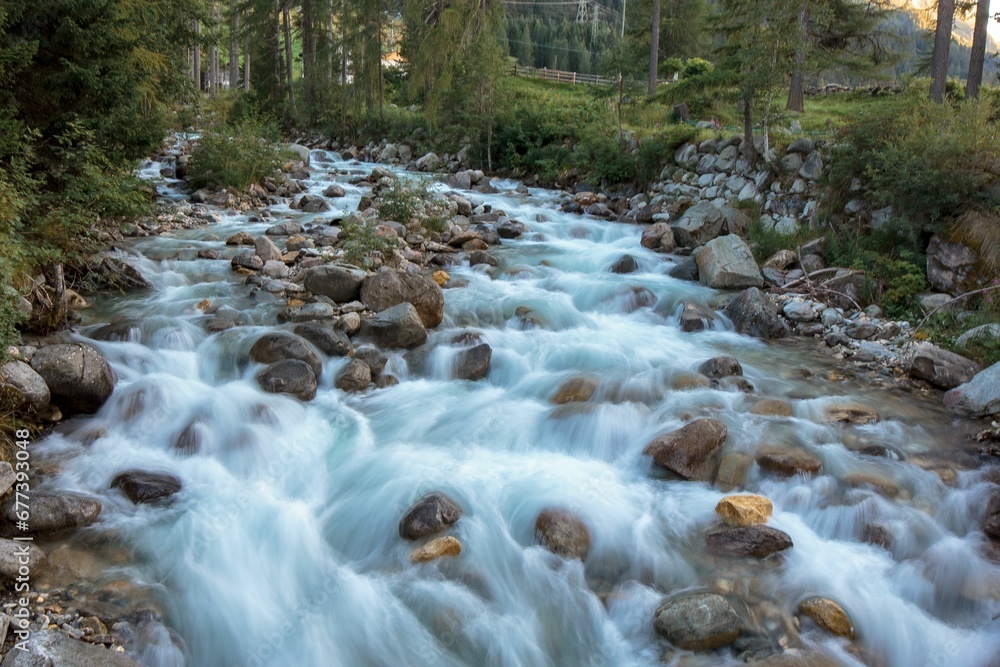Beautiful fast-flowing river in the rocky mountains among the pine trees Beautiful fast-flowing river in the rocky mountains among the pine trees