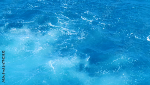 Turquoise ocean sea water white wave splashing deep blue sea. Bird eye view monster wave splash on rock. Tropical sea beach in summer seaside outdoor. Ocean island beautiful dramatic landscape.