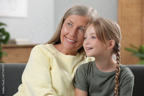 Happy grandmother with her granddaughter at home