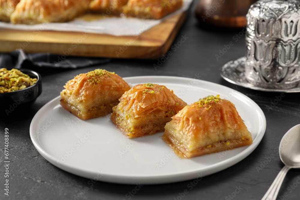 Delicious sweet baklava with pistachios on black table, closeup Delicious sweet baklava with pistachios on black table, closeup