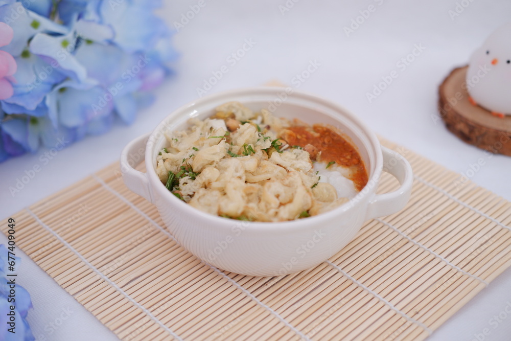 Bubur ayam or rice porridge with shredded chicken Bubur ayam or rice porridge with shredded chicken