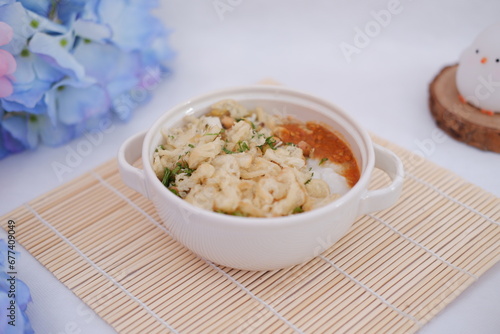 Bubur ayam or rice porridge with shredded chicken