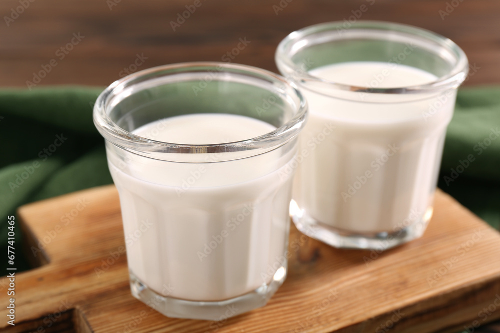 Glasses of tasty milk on table, closeup Glasses of tasty milk on table, closeup
