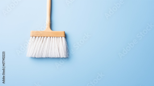 Cleaning brush on plain blue background
