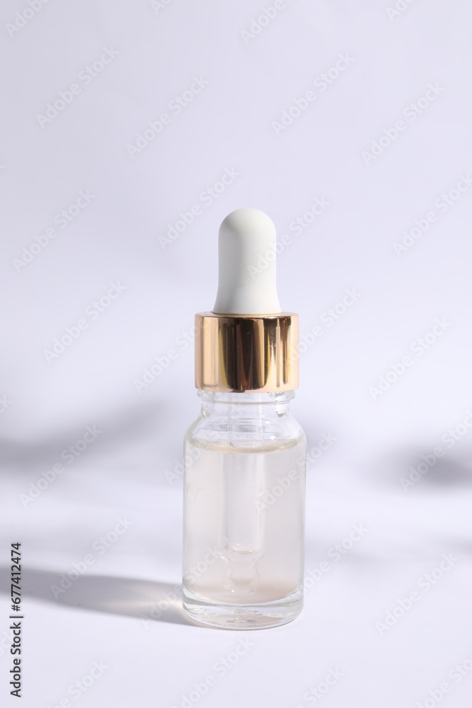 Naklejka premium Bottle of cosmetic serum on white background