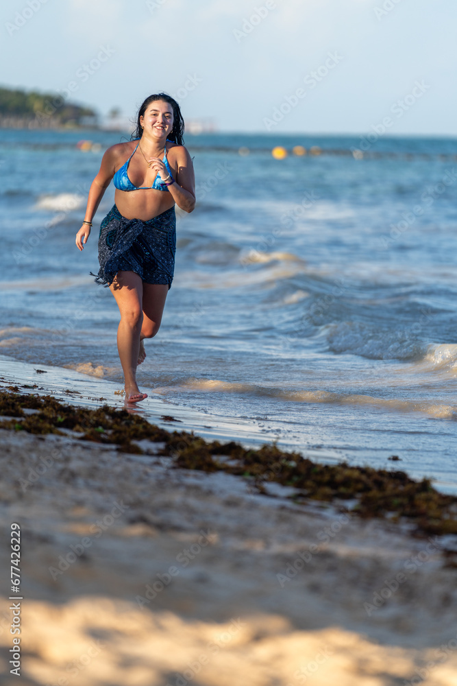 Vital woman running along the edge of the sea Vital woman running along the edge of the sea