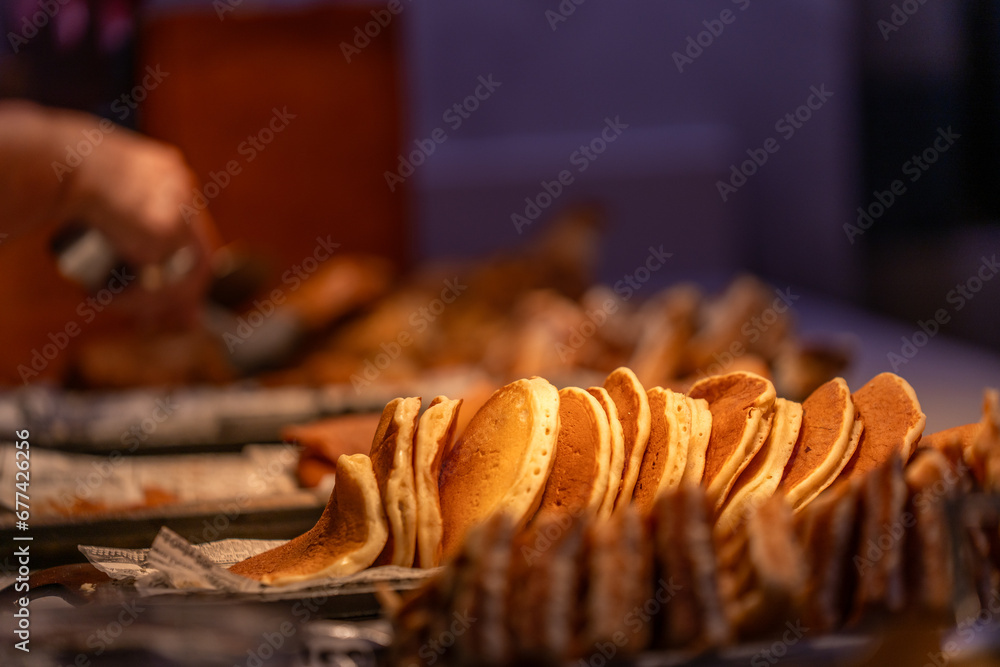 Line of pancakes in the counter of a buffet restaurant - obrazy, fototapety, plakaty 