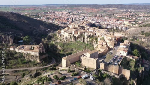 Picturesque view from drone of historic district of Cuenca city on steep spur above deep gorges of Jucar and Huecar rivers on sunny spring day, Spain photo
