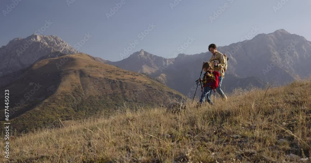 Woman and kid conquer mountain, trekking poles backpacks. Outdoor exploration, Inspire, joys of outdoor exploration, thrill of adventure, hiking in serene morning glow, childish mischief. Family trip