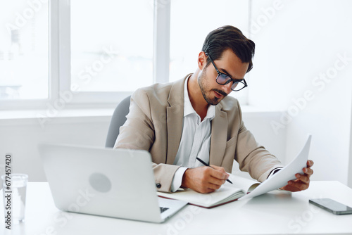 Happy document company paper businessman looking planning office holding laptop suit