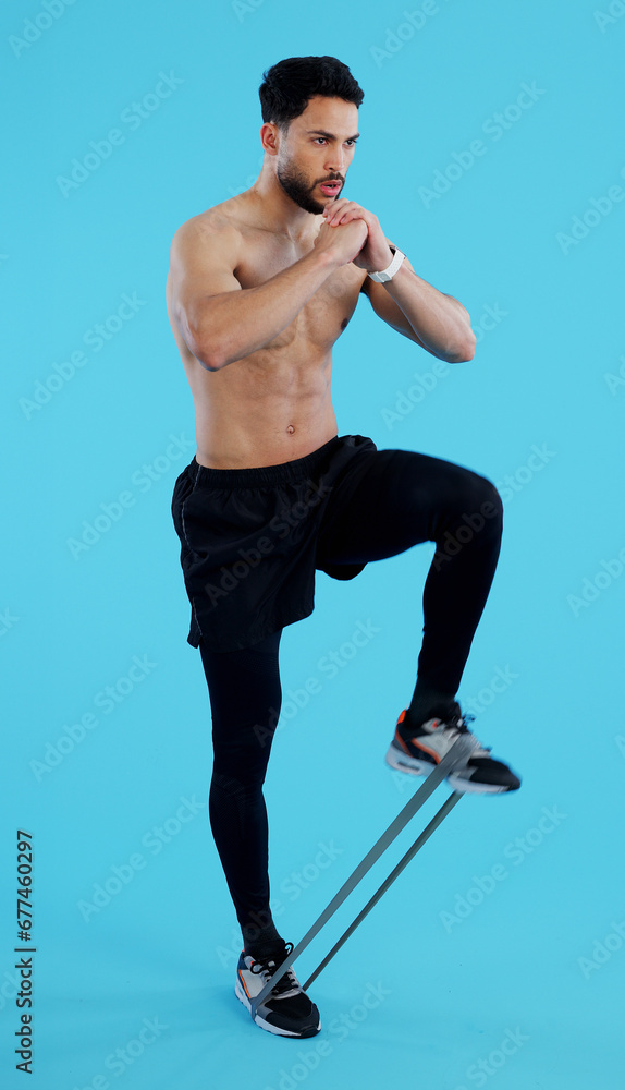Man, legs and resistance band in fitness, workout or training against a blue studio background. Male person, athlete or serious model with straps for cardio exercise, endurance or stamina on mockup Man, legs and resistance band in fitness, workout or training against a blue studio background. Male person, athlete or serious model with straps for cardio exercise, endurance or stamina on mockup