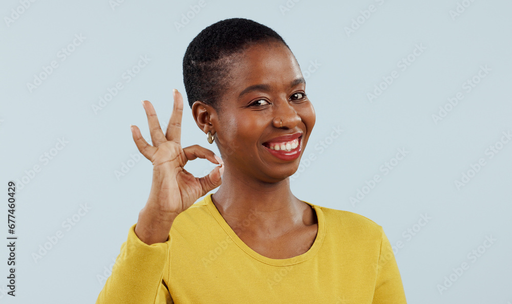 Happy black woman, portrait and OK sign for success or approval against a gray studio background. Face of African female person or model smile with like emoji, yes or okay for perfect or good job Happy black woman, portrait and OK sign for success or approval against a gray studio background. Face of African female person or model smile with like emoji, yes or okay for perfect or good job