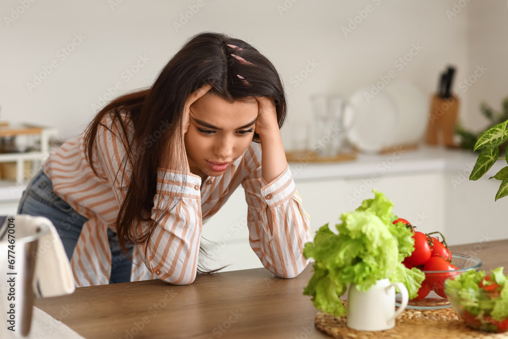 Young woman having panic attack in kitchen Young woman having panic attack in kitchen
