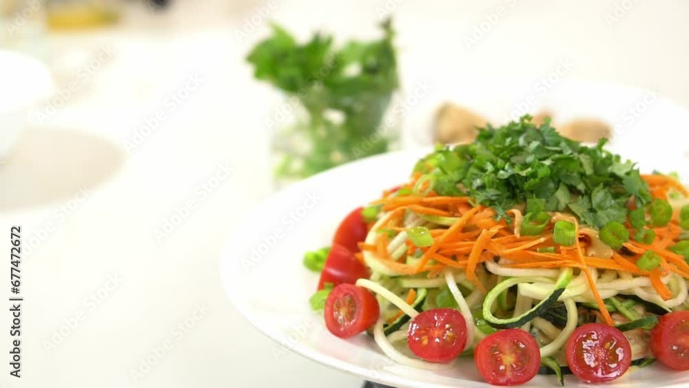 Plated zucchini noodles on lazy Susan rotating platter garnished cilantro Plated zucchini noodles on lazy Susan rotating platter garnished cilantro