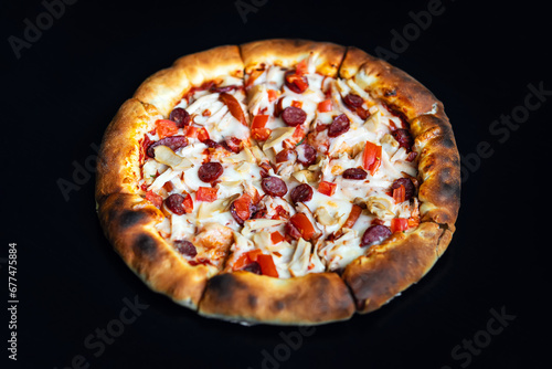 Delicious classic italian Pizza Pepperoni with sausages and cheese mozzarella. black dark background